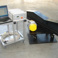 A set up of vibrational equipment type VZ 4 with a sprung table for vibrational treatment of assemblies with small dimensions